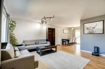 a living room with a couch and a table at Furnished Patio! Suburban Gem 11 Mi to Dtwn Denver in Arvada