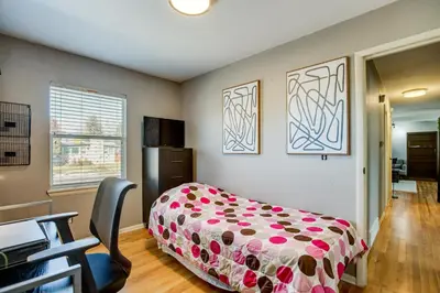 a bedroom with a bed and a desk and a chair at Furnished Patio! Suburban Gem 11 Mi to Dtwn Denver in Arvada