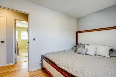 a bedroom with a bed and a bathroom at Furnished Patio! Suburban Gem 11 Mi to Dtwn Denver in Arvada
