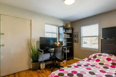 a bedroom with a bed and a desk with a computer at Furnished Patio! Suburban Gem 11 Mi to Dtwn Denver in Arvada
