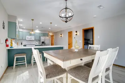 a kitchen and dining room with a wooden table and chairs at Private Pool and Yard Spacious Brighton Home! in Brighton