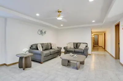 a living room with two couches and a table at 6 Mi to Barr Lake Apt with Yard and Pool Access! in Brighton