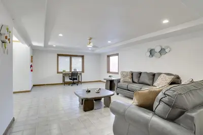 a living room with a couch and a table at 6 Mi to Barr Lake Apt with Yard and Pool Access! in Brighton