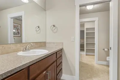 a bathroom with a sink and a mirror at Ember and Ash Designer Home with King Beds, Games in Fort Collins
