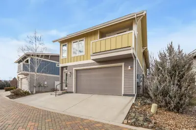 a house with a garage in front of it at Ember and Ash Designer Home with King Beds, Games in Fort Collins