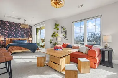 a living room with a couch and a bed at The Revive Loft with Balcony, Workspace and Bikes in Fort Collins