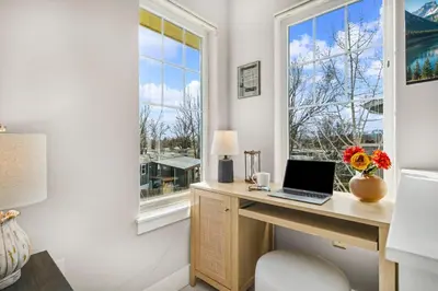 a desk with a laptop on it next to a window at The Revive Loft with Balcony, Workspace and Bikes in Fort Collins