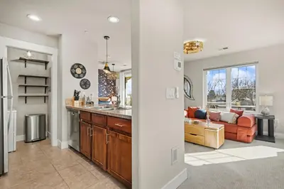 a kitchen and living room with a couch at The Revive Loft with Balcony, Workspace and Bikes in Fort Collins