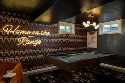a pool table in a room with a sign home on the range at The Wild Western - 5Bed, Hot Tub, Sauna, Mini Putt, Fire Pit in Denver