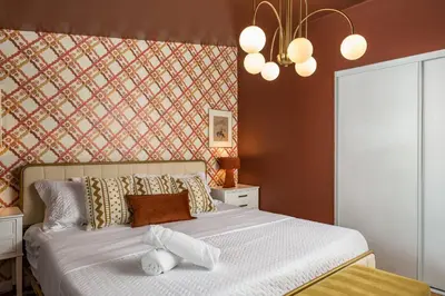 a bedroom with a white bed with a wall at The Wild Western - 5Bed, Hot Tub, Sauna, Mini Putt, Fire Pit in Denver