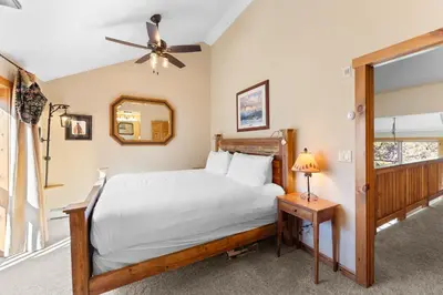 a bedroom with a large bed and a mirror at Seasons at Keystone 1841 in Keystone