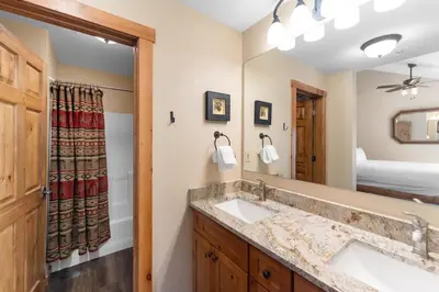 a bathroom with two sinks and a large mirror at Seasons at Keystone 1841 in Keystone