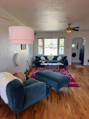 a living room with a blue couch and a living room with at Temple Of Divine Light in Boulder