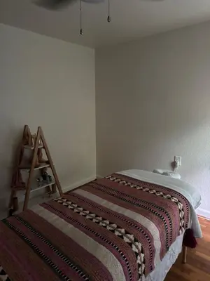 a bedroom with a bed with a blanket on it at Temple Of Divine Light in Boulder