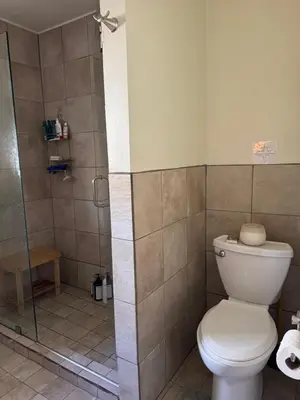 a bathroom with a toilet and a shower at Temple Of Divine Light in Boulder