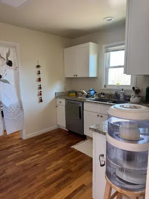 a kitchen with white cabinets and a counter top at Temple Of Divine Light in Boulder