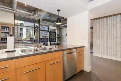 a kitchen with two sinks and a large window at Union Station downtown and gameday retreat! in Denver
