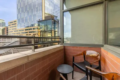 a balcony with two chairs and a window at Union Station downtown and gameday retreat! in Denver