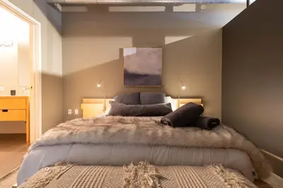 a bedroom with a large bed with a large blanket at Union Station downtown and gameday retreat! in Denver