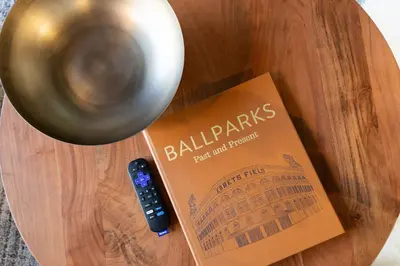 a book and a remote control sitting on a table at Union Station downtown and gameday retreat! in Denver