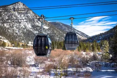 two gondolas on a ski lift in the snow at Kindred Resort Luxury Ski In, Ski Out 2 Bedroom Residence At The River Run Gondola in Dillon