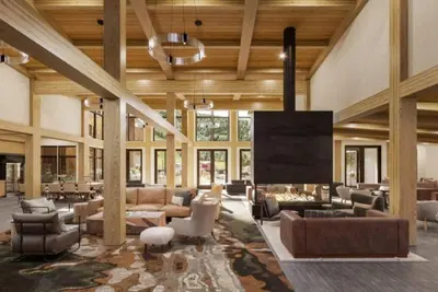 a large living room with couches and a large screen at Kindred Resort Luxury Ski In, Ski Out 2 Bedroom Residence At The River Run Gondola in Dillon
