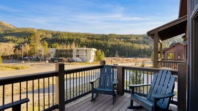 two blue chairs on a porch with a view of a mountain at Fireplace Game Room Mountain Views Near Golf Dining Keystone River Run by AvantStay in Dillon