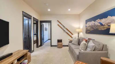 a living room with a couch and a table at Fireplace Game Room Mountain Views Near Golf Dining Keystone River Run by AvantStay in Dillon