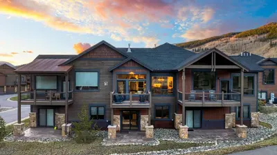 a large house with a mountain in the background at Fireplace Game Room Mountain Views Near Golf Dining Keystone River Run by AvantStay in Dillon