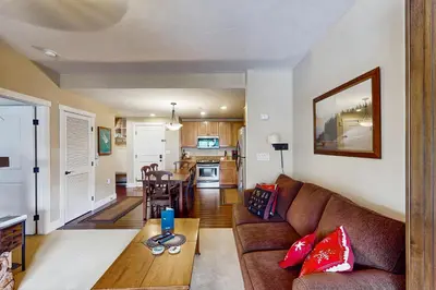 a living room with a couch and a table at Base Camp One 413 in Granby