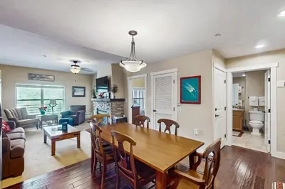 a dining room and living room with a table and chairs at Base Camp One 413 in Granby