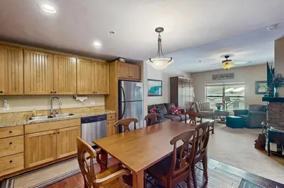 a kitchen and dining room with a table and chairs at Base Camp One 413 in Granby