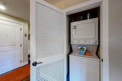a laundry room with a refrigerator and a microwave at Base Camp One 314 in Granby