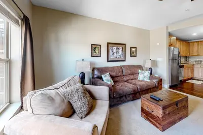 a living room with a couch and a table at Base Camp One 314 in Granby