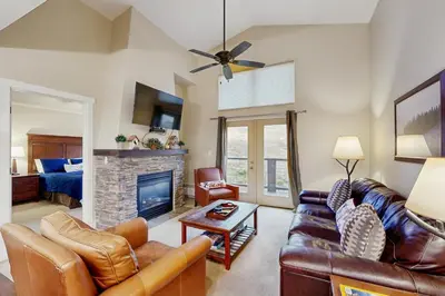 a living room with a couch and a fireplace at Base Camp One 403 in Granby