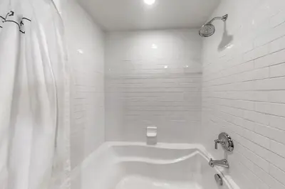 a white bathroom with a tub and a shower at Base Camp One 316 in Granby