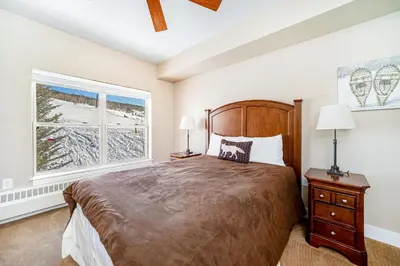 a bedroom with a large bed and a window at Base Camp One 201 in Granby