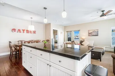 an open kitchen and living room with a large island at Base Camp One 201 in Granby