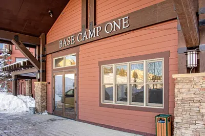 a pink building with a sign that reads base camp one at Base Camp One 201 in Granby