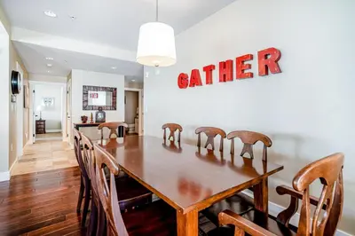 a dining room table with chairs and a sign that reads eater at Base Camp One 201 in Granby