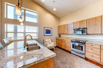 a kitchen with a sink and a stove at Base Camp One Penthouse 416C in Granby