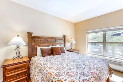 a bedroom with a large bed and a window at Base Camp One Penthouse 416C in Granby