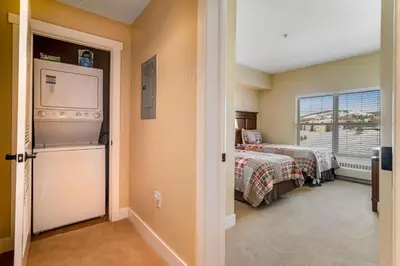a room with two beds and a tv and a window at Base Camp One 412 in Granby