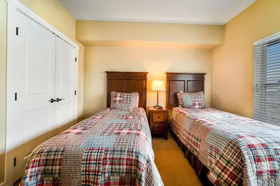 two beds sitting next to each other in a bedroom at Base Camp One 412 in Granby