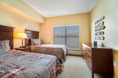a bedroom with two beds and a window at Base Camp One 412 in Granby