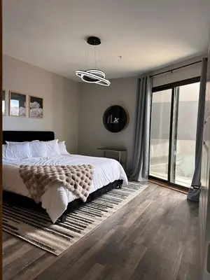 a bedroom with a large bed and a large window at Luxe 2BR condo in Denver's Rino Art District in Denver