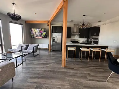 a large living room with a kitchen and a living room at Luxe 2BR condo in Denver's Rino Art District in Denver
