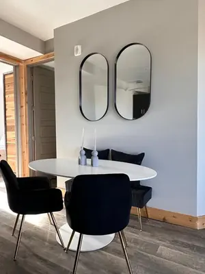 a dining room with a white table and black chairs at Luxe 2BR condo in Denver's Rino Art District in Denver