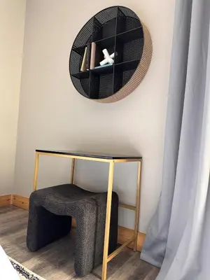 a wicker basket hanging on a wall next to a chair at Luxe 2BR condo in Denver's Rino Art District in Denver