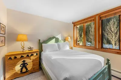 a bedroom with a bed and a window at Timbers 3080 in Keystone